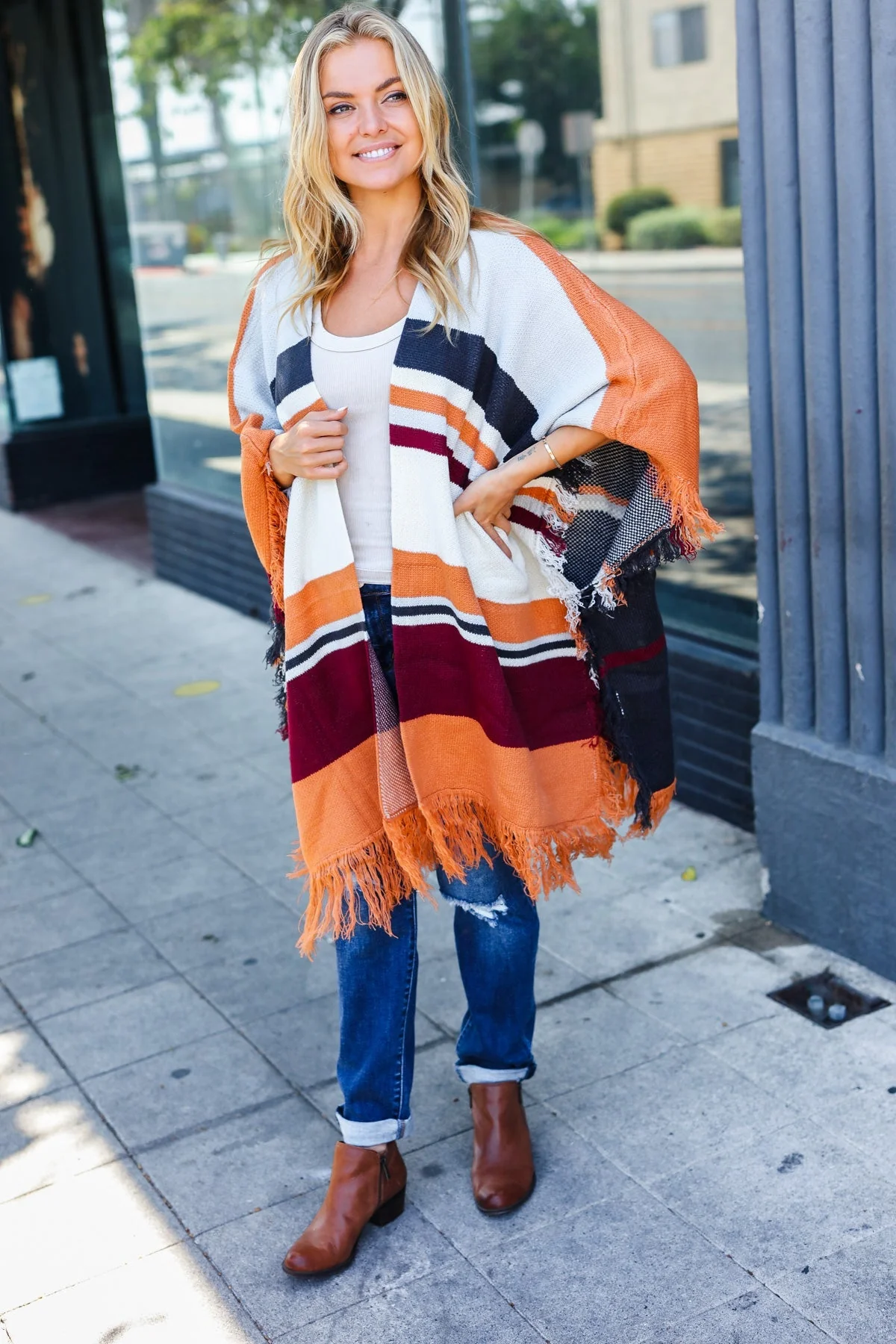 Zoe | Follow Me Rust colored open poncho with multi colored stripes and tassel fringes - Image 3